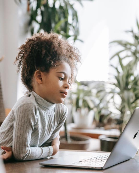 Child working calmly at a laptop